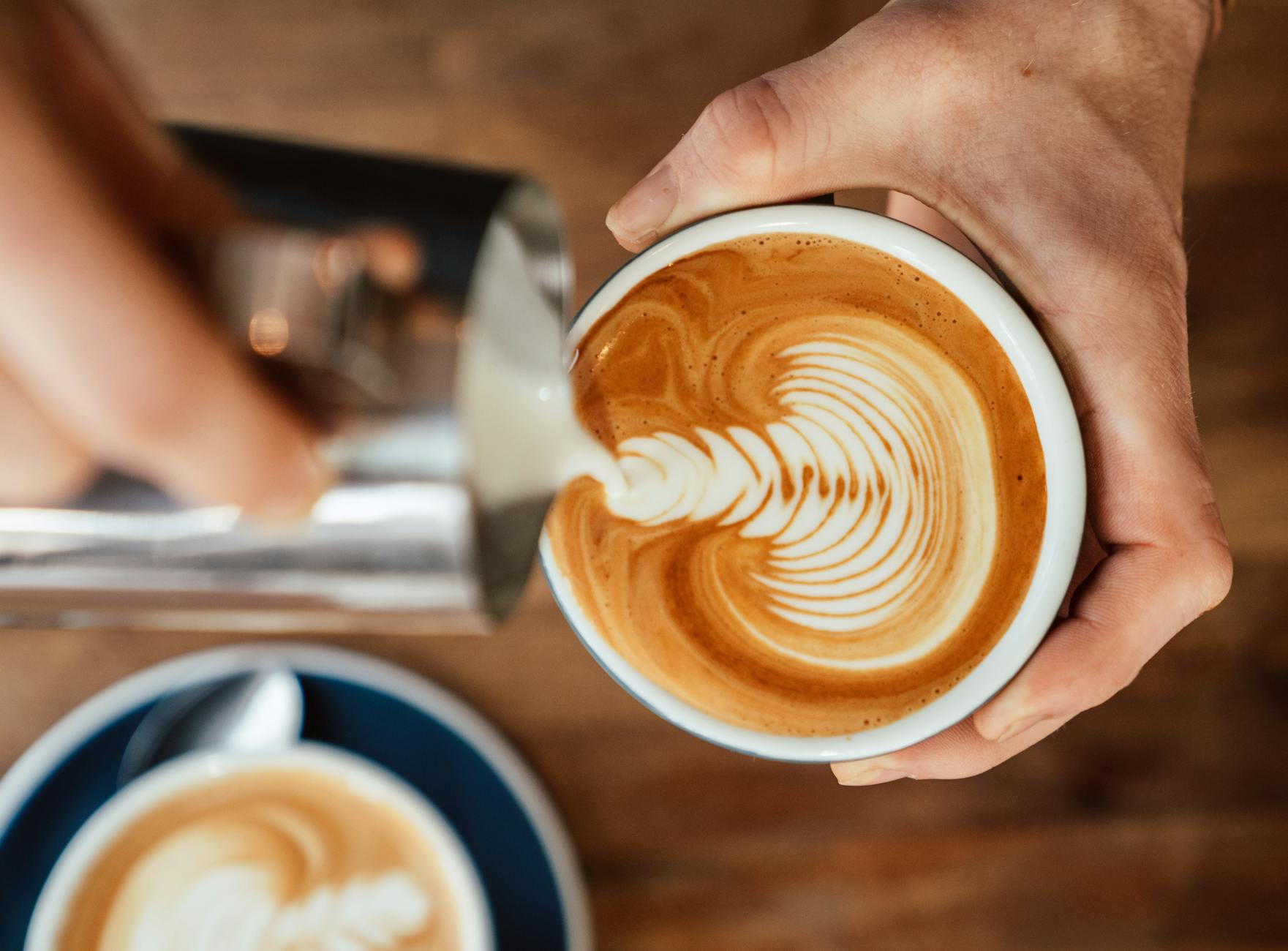 Un camarero prepara un café con leche